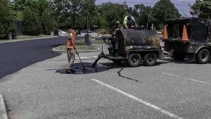 Mixing sealer for parking lot sealcoating in North Amityville, New York.